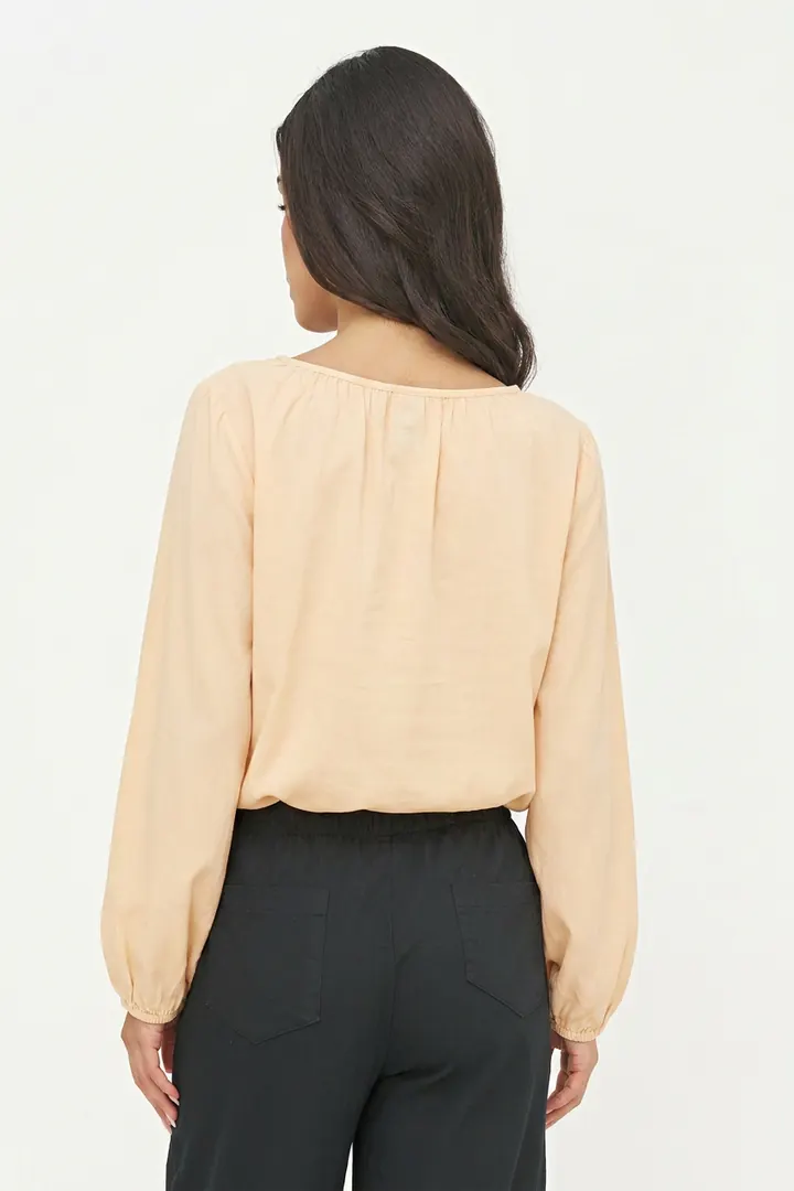 Pale apricot blouse, back pose