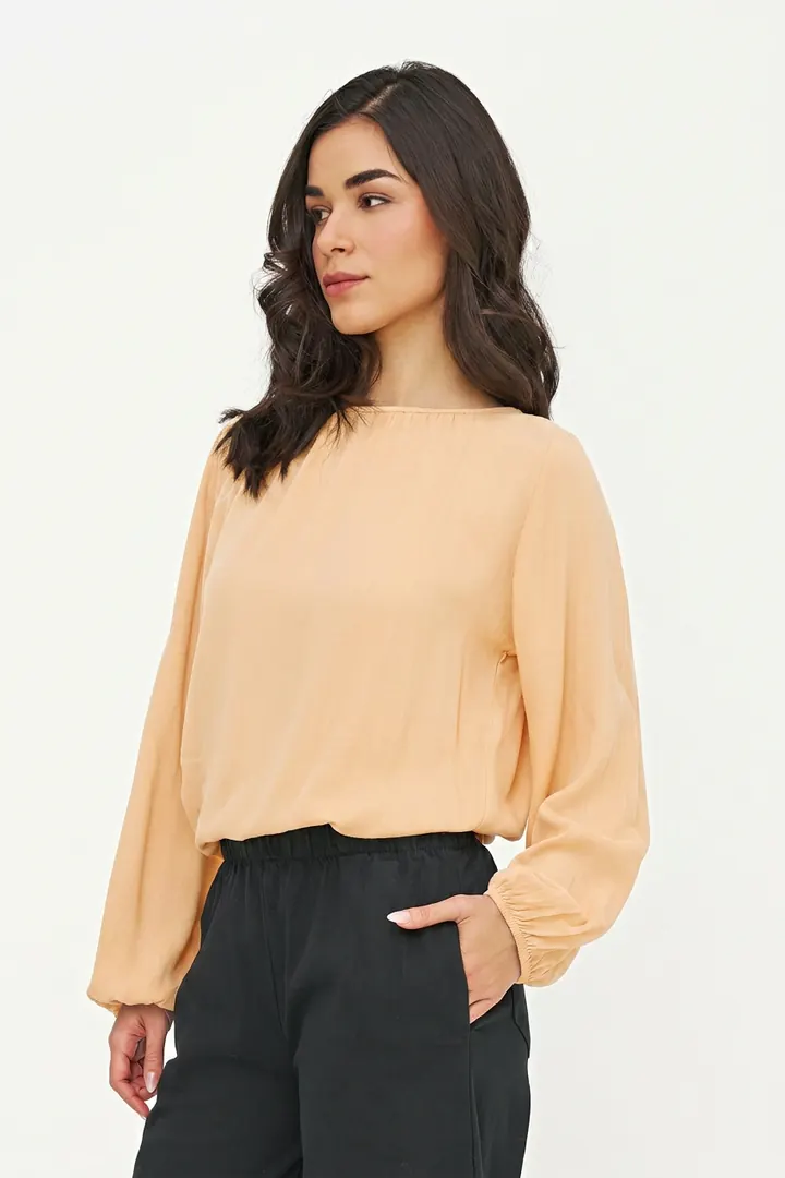 Pale apricot blouse, three-quarter pose